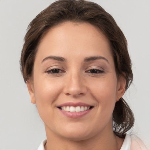 Joyful white young-adult female with medium  brown hair and brown eyes