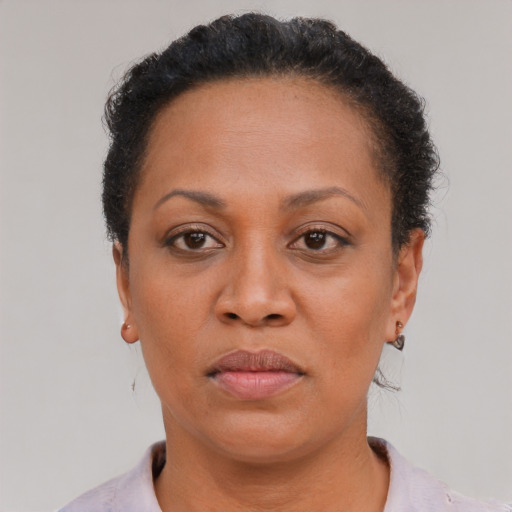 Neutral latino adult female with short  brown hair and brown eyes