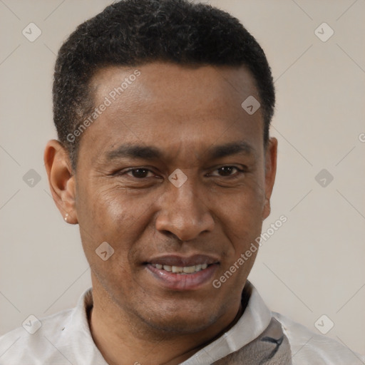 Joyful latino adult male with short  brown hair and brown eyes
