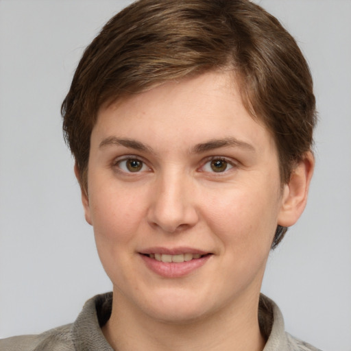 Joyful white young-adult female with short  brown hair and grey eyes