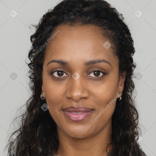 Joyful black young-adult female with long  brown hair and brown eyes