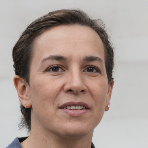 Joyful white adult female with short  brown hair and brown eyes