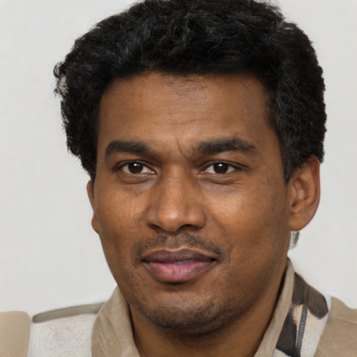 Joyful latino adult male with short  black hair and brown eyes