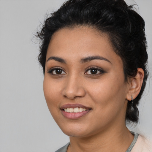 Joyful latino young-adult female with medium  black hair and brown eyes