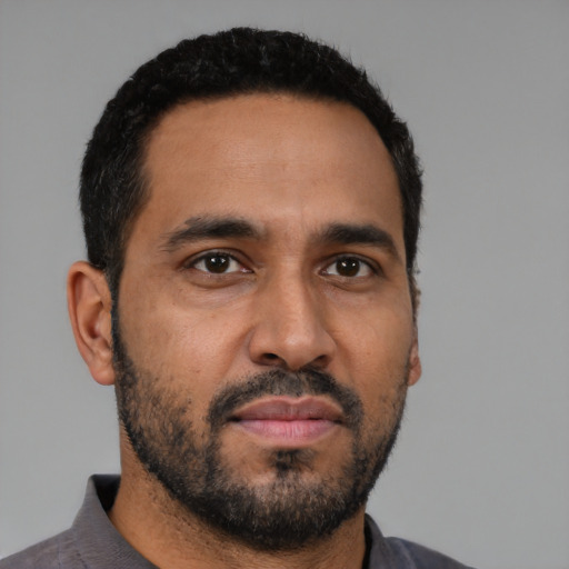 Neutral latino young-adult male with short  black hair and brown eyes