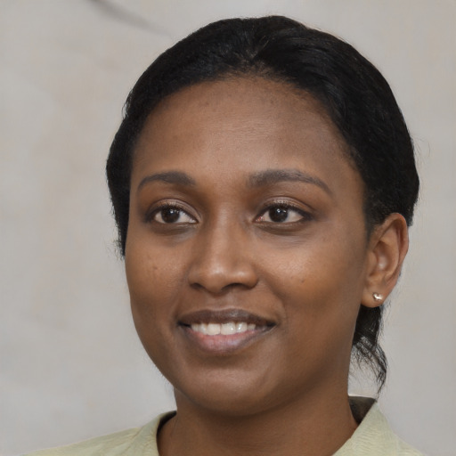 Joyful black young-adult female with medium  black hair and brown eyes