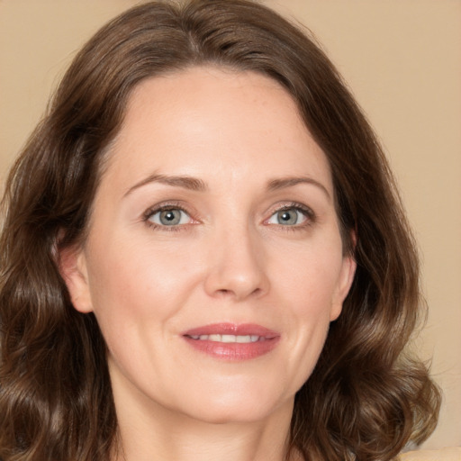 Joyful white adult female with medium  brown hair and green eyes