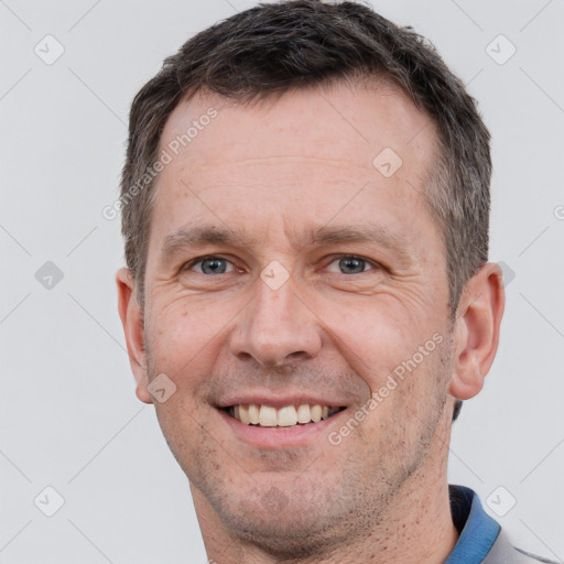 Joyful white adult male with short  brown hair and grey eyes