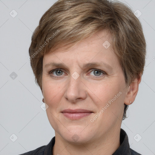 Joyful white adult female with short  brown hair and grey eyes