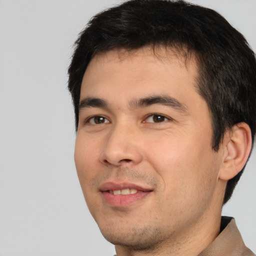 Joyful white young-adult male with short  black hair and brown eyes