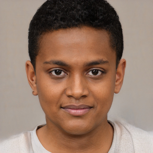 Joyful black child male with short  brown hair and brown eyes