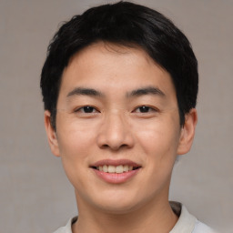 Joyful asian young-adult male with short  black hair and brown eyes