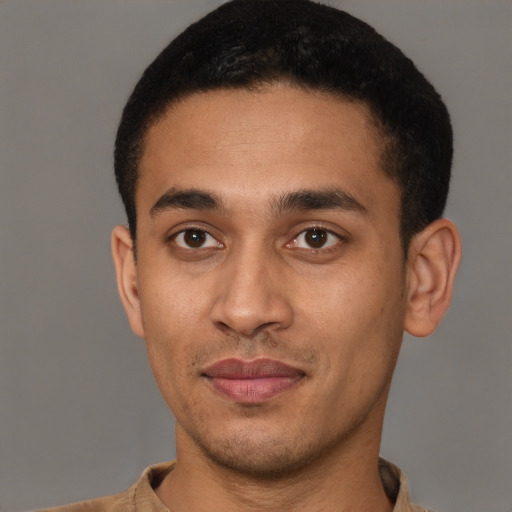 Joyful latino young-adult male with short  brown hair and brown eyes