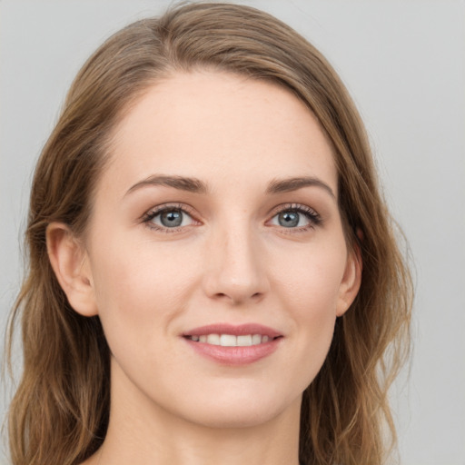 Joyful white young-adult female with long  brown hair and blue eyes