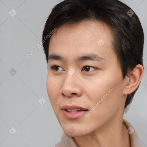 Joyful asian young-adult male with short  brown hair and brown eyes