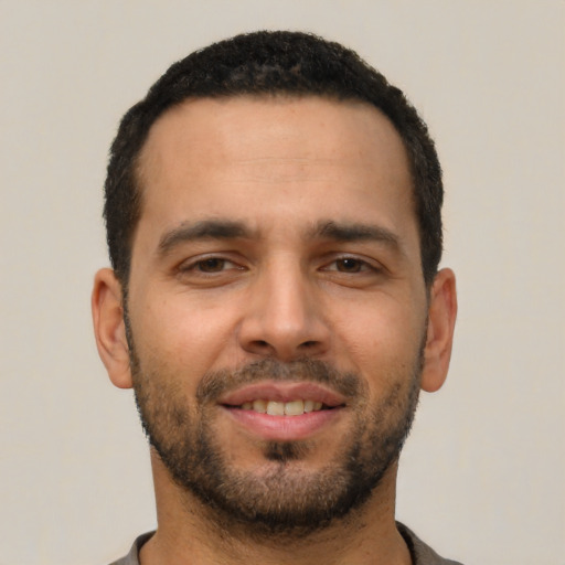 Joyful white young-adult male with short  black hair and brown eyes