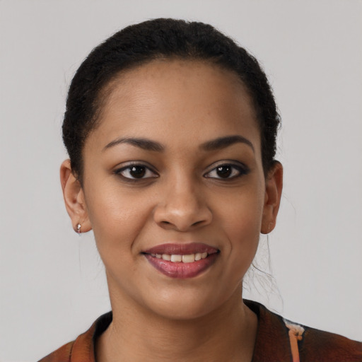Joyful black young-adult female with short  brown hair and brown eyes