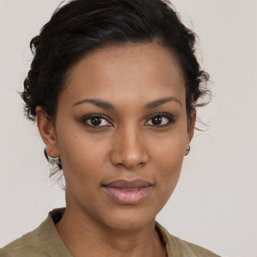 Joyful black young-adult female with medium  brown hair and brown eyes