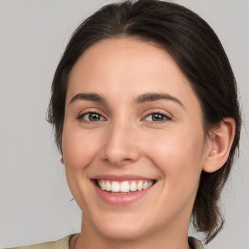 Joyful white young-adult female with medium  brown hair and brown eyes