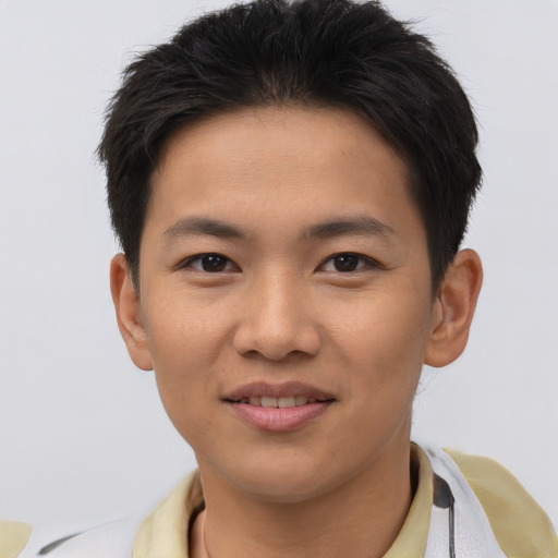 Joyful asian young-adult male with short  brown hair and brown eyes