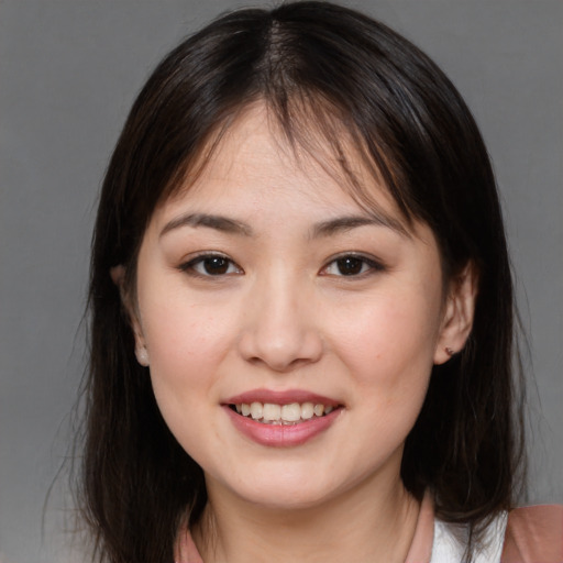 Joyful asian young-adult female with medium  brown hair and brown eyes
