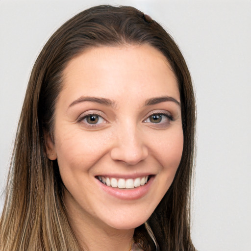 Joyful white young-adult female with long  brown hair and brown eyes