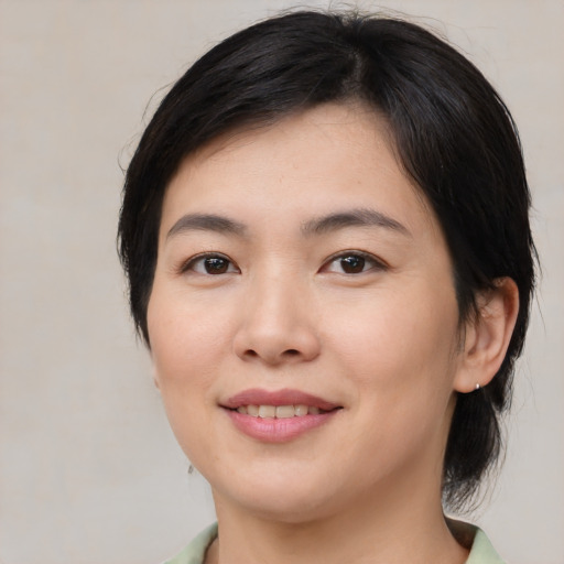 Joyful asian young-adult female with medium  brown hair and brown eyes