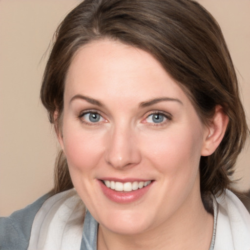 Joyful white young-adult female with medium  brown hair and blue eyes