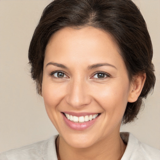 Joyful white young-adult female with medium  brown hair and brown eyes