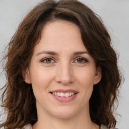 Joyful white young-adult female with long  brown hair and green eyes