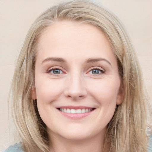 Joyful white young-adult female with long  brown hair and blue eyes