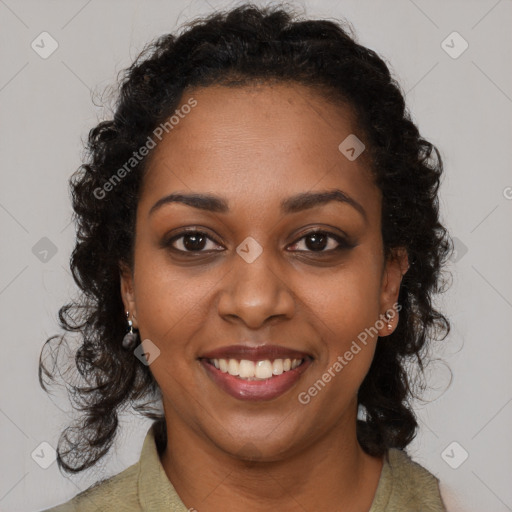 Joyful black young-adult female with long  brown hair and brown eyes