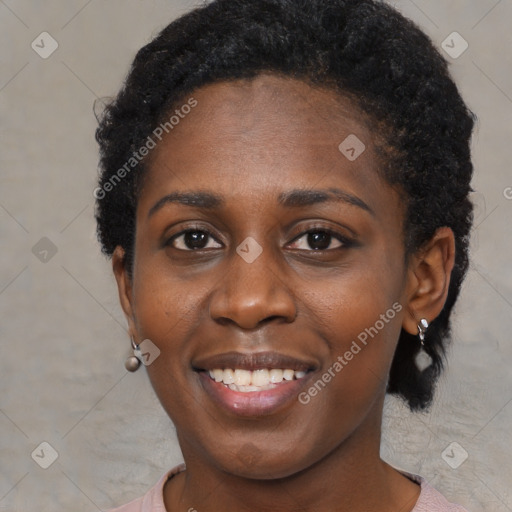 Joyful black young-adult female with short  brown hair and brown eyes