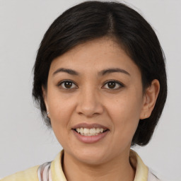 Joyful asian young-adult female with medium  brown hair and brown eyes