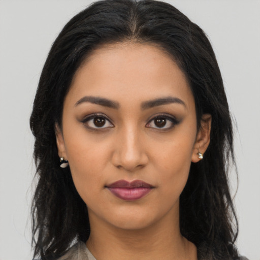 Neutral latino young-adult female with long  brown hair and brown eyes