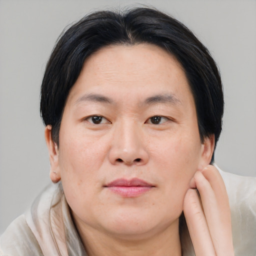Joyful asian adult male with medium  brown hair and brown eyes