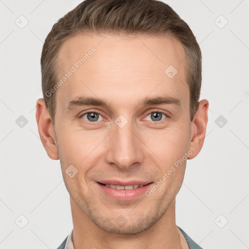 Joyful white young-adult male with short  brown hair and grey eyes