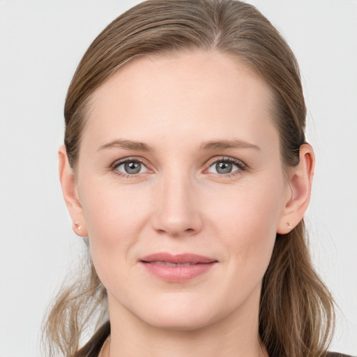 Joyful white young-adult female with medium  brown hair and blue eyes