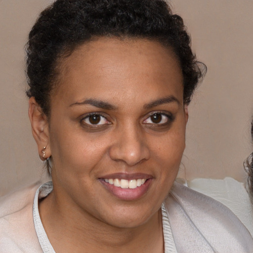 Joyful black young-adult female with short  brown hair and brown eyes