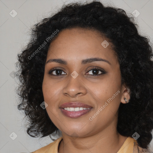 Joyful black young-adult female with long  brown hair and brown eyes