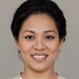 Joyful asian young-adult female with short  brown hair and brown eyes