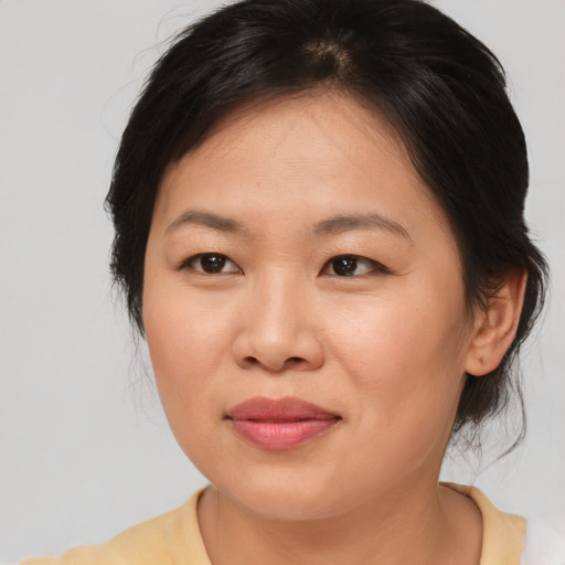 Joyful asian young-adult female with medium  brown hair and brown eyes