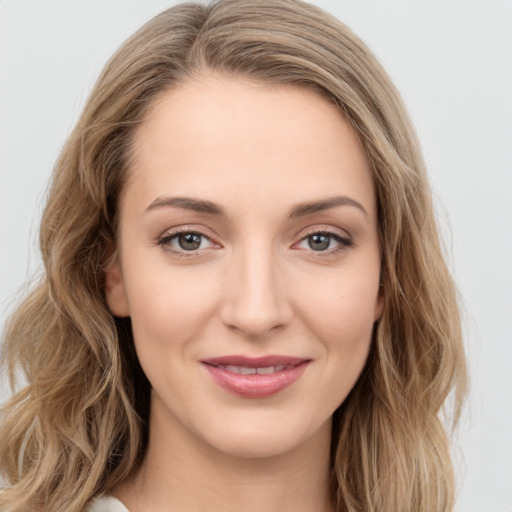 Joyful white young-adult female with long  brown hair and green eyes