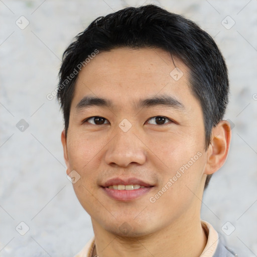 Joyful asian young-adult male with short  black hair and brown eyes