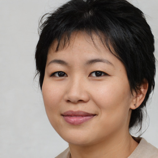 Joyful asian young-adult female with medium  brown hair and brown eyes