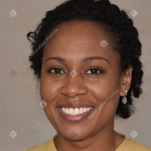 Joyful black adult female with short  brown hair and brown eyes