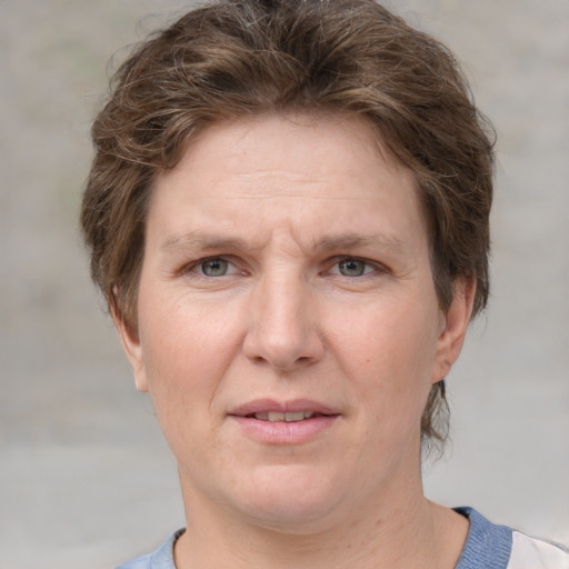 Joyful white adult female with short  brown hair and grey eyes