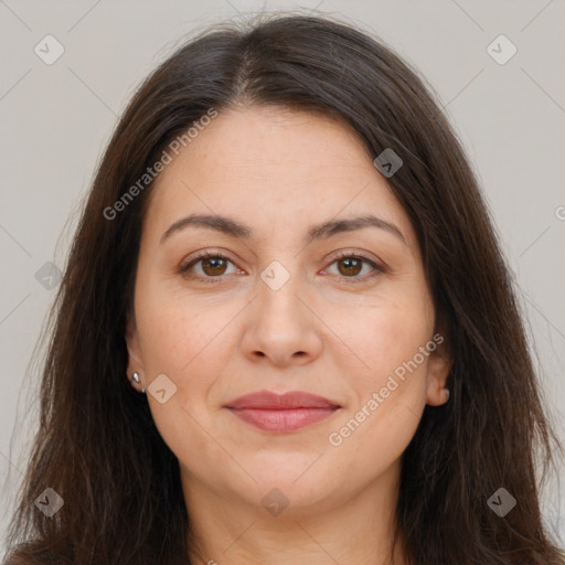 Joyful white adult female with long  brown hair and brown eyes