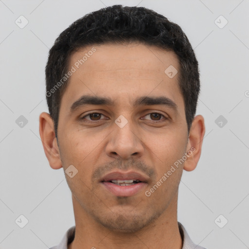 Joyful latino young-adult male with short  black hair and brown eyes