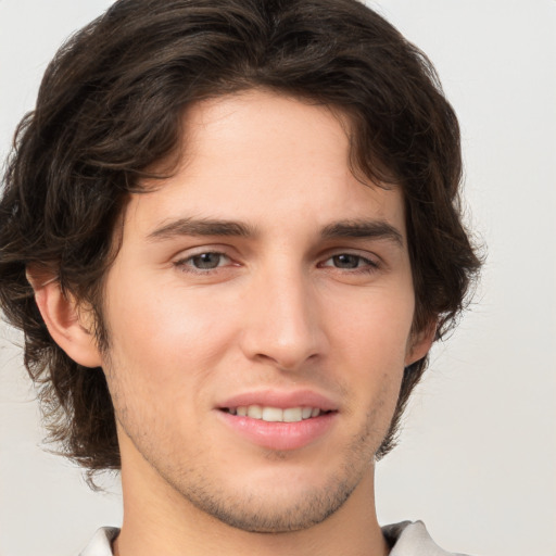 Joyful white young-adult male with medium  brown hair and brown eyes